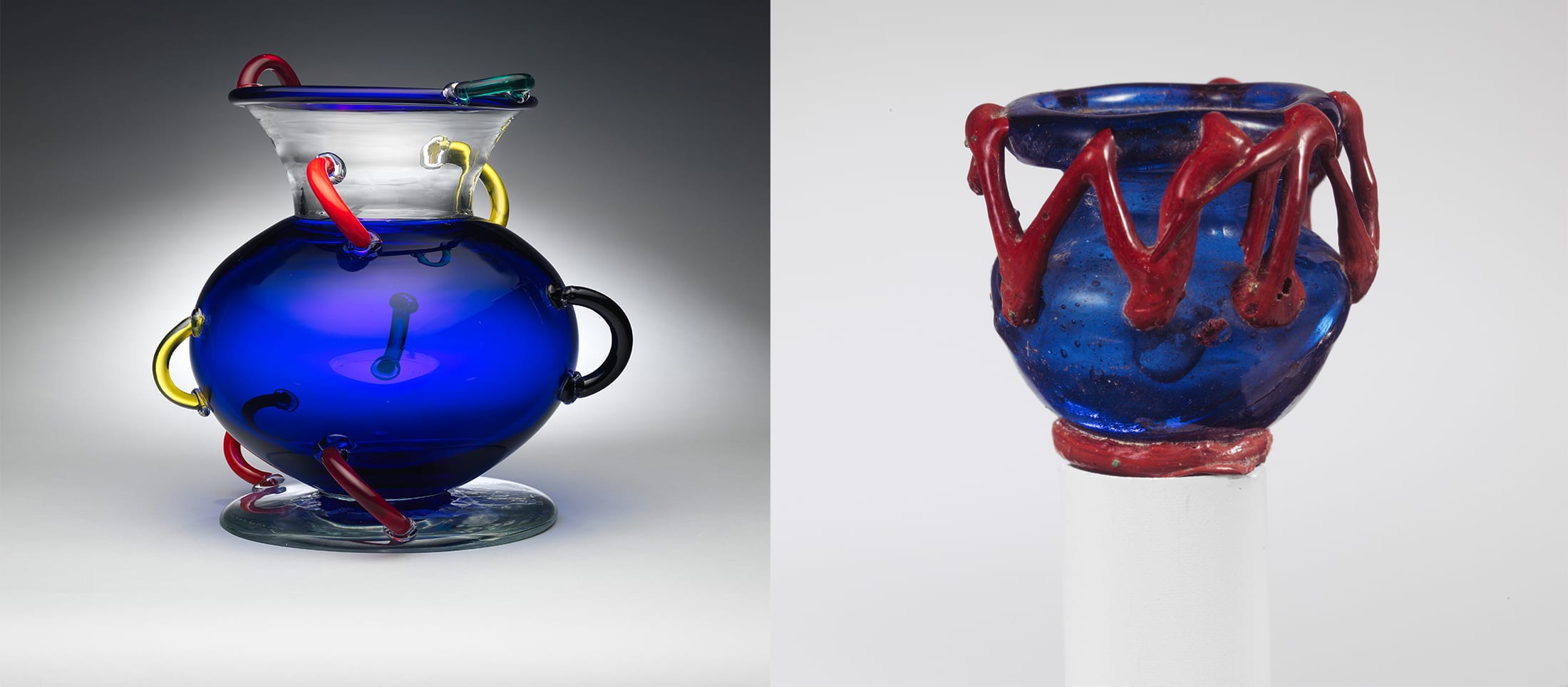 Two blue glass sculptures featuring unique intertwined colorful designs and patterns.