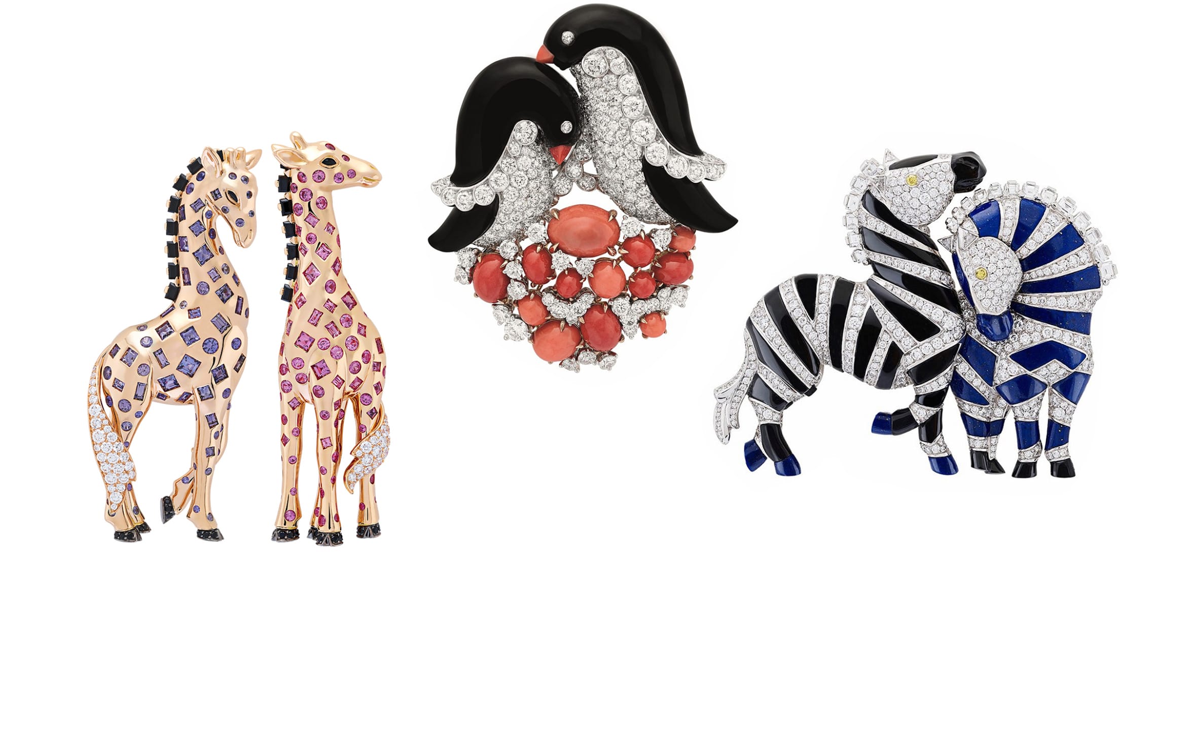 Three jeweled animal brooches featuring giraffes, penguins with coral accents, and zebras in colorful designs.