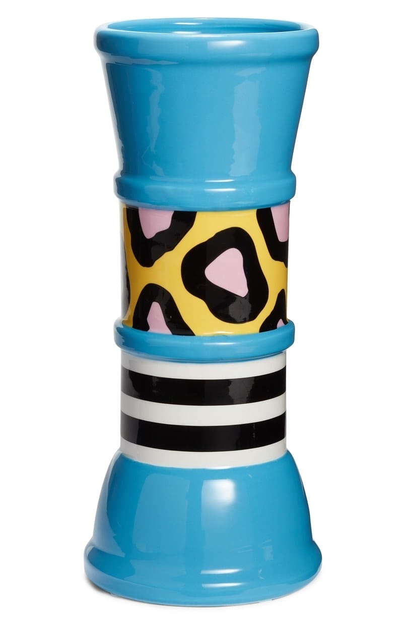 Colorful, patterned ceramic vase with blue, yellow, black, and pink sections featuring geometric and striped designs.