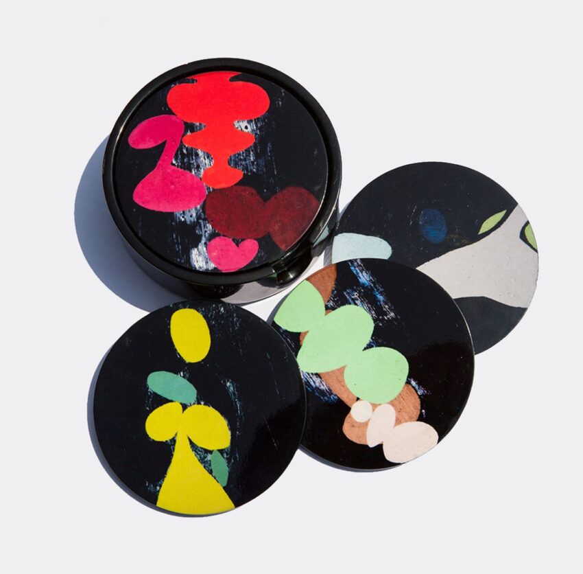 Abstract art coasters with colorful designs in circular shapes, arranged in a fan pattern.