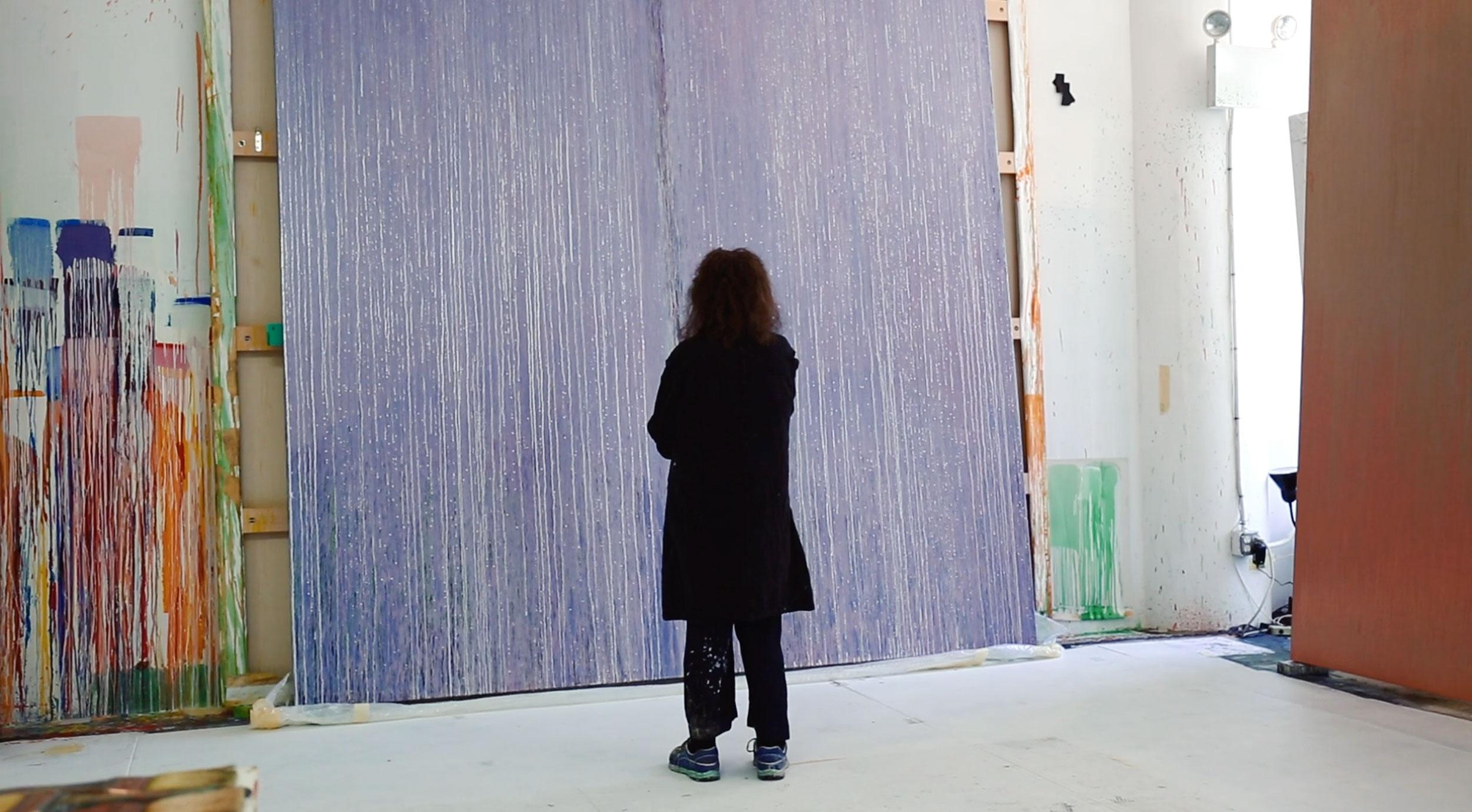Pat Steir beside her painting, "Lila Judith"