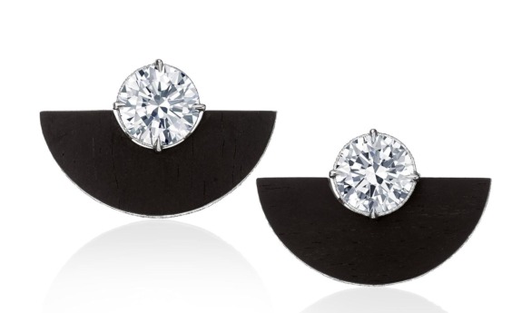 Black and silver geometric earrings with large round crystals on white background.