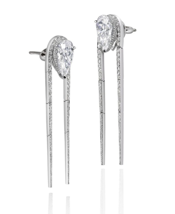 Elegant drop earrings with teardrop-shaped diamonds and vertical silver strands on a white background.