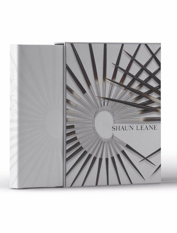 Shaun Leane book with intricate metallic design cover and embossed sunburst pattern, placed against a white background.