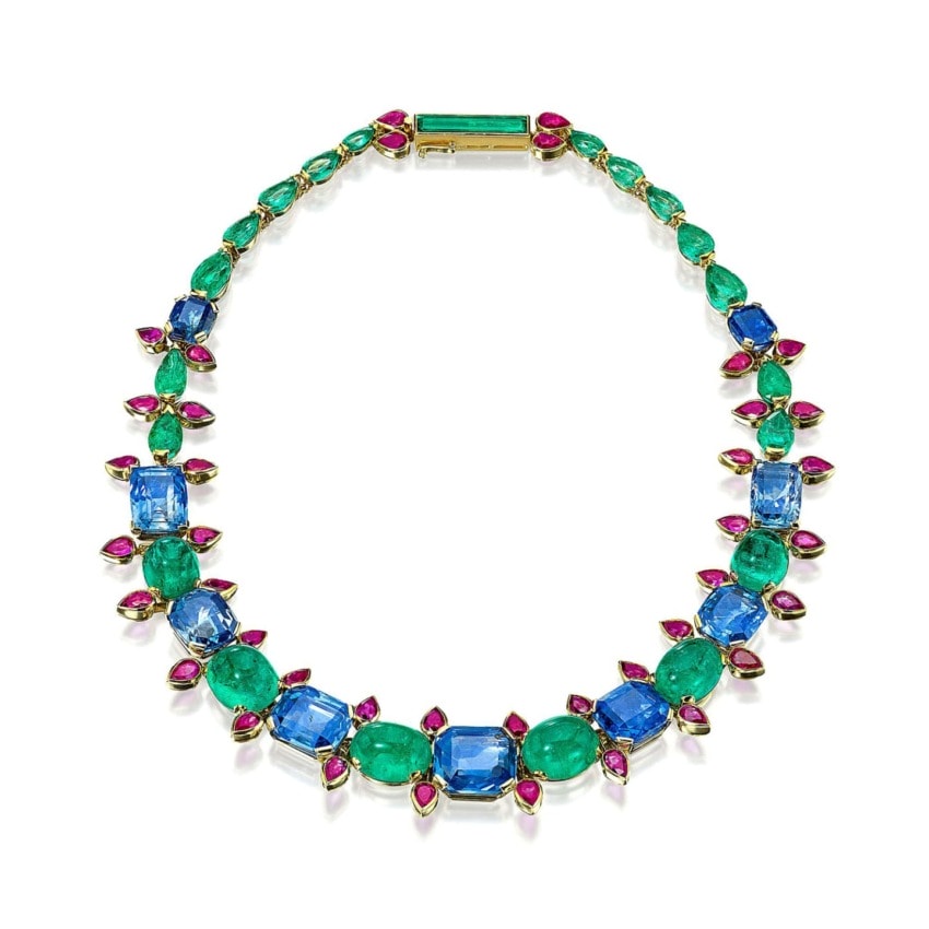 Colorful gemstone necklace featuring blue, green, and pink stones arranged in a striking pattern.