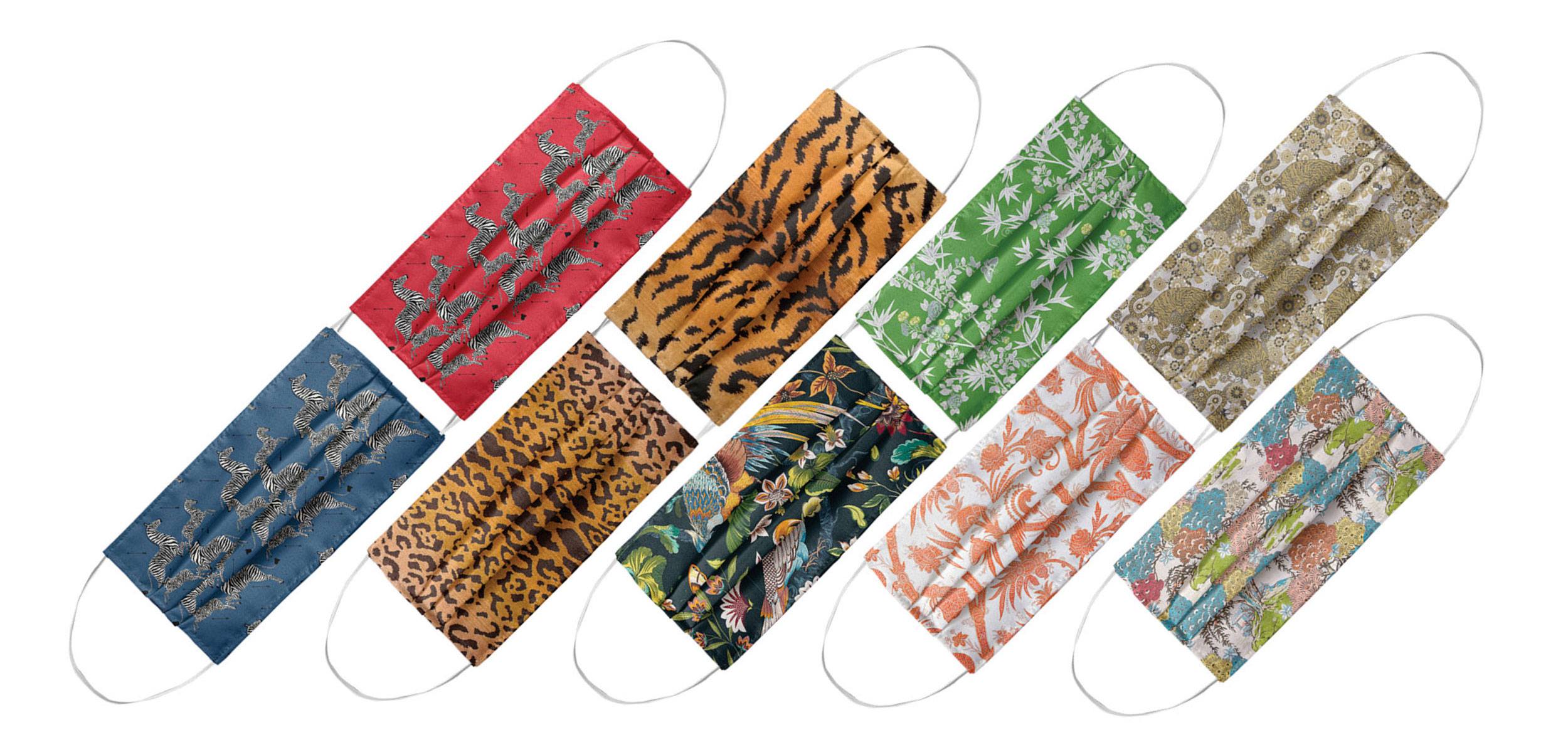 Colorful fabric face masks with various patterns, including animals, leaves, and abstract designs, arranged in a row.