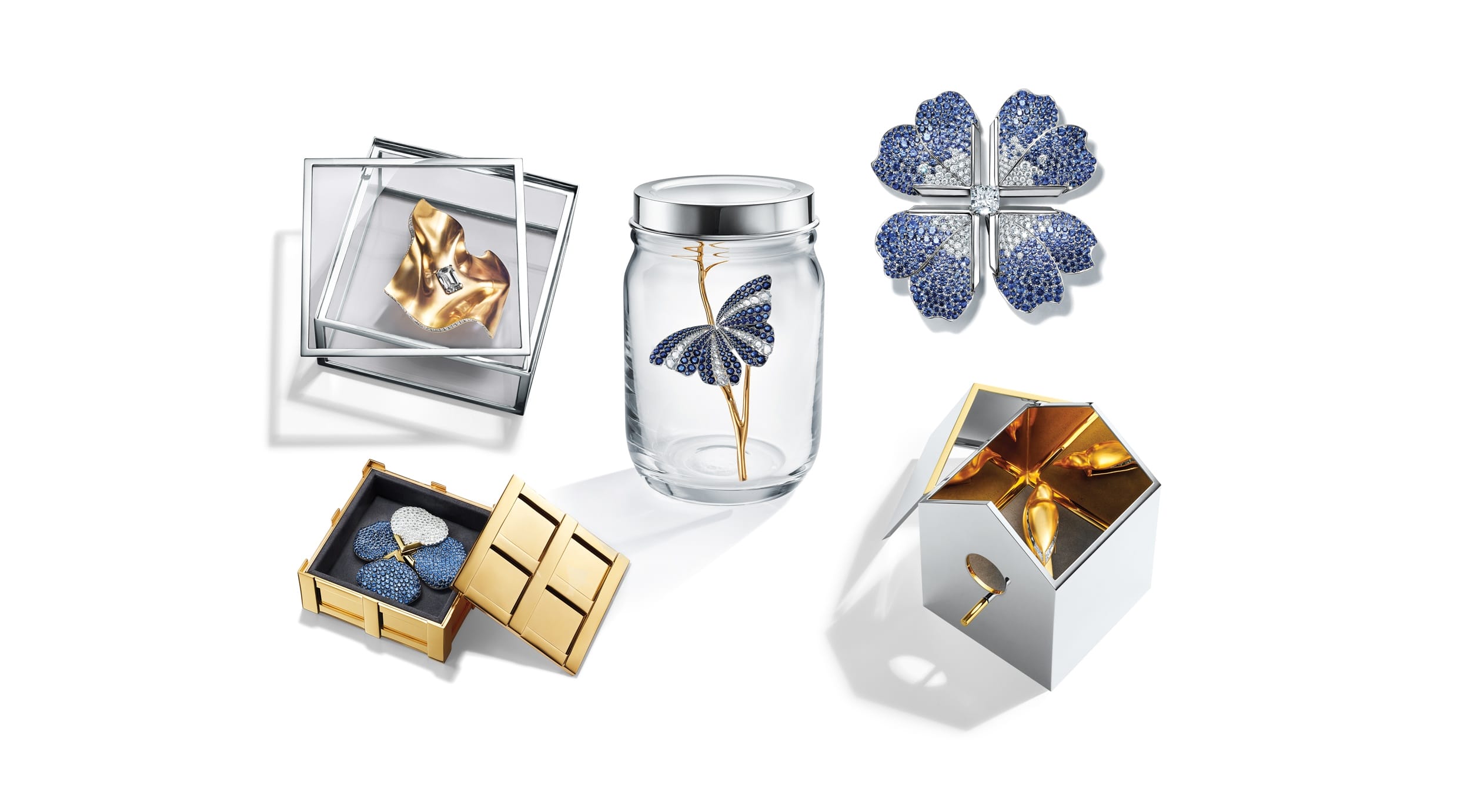 Collection of artistic home decor items featuring butterfly and flower designs in various decorative containers.