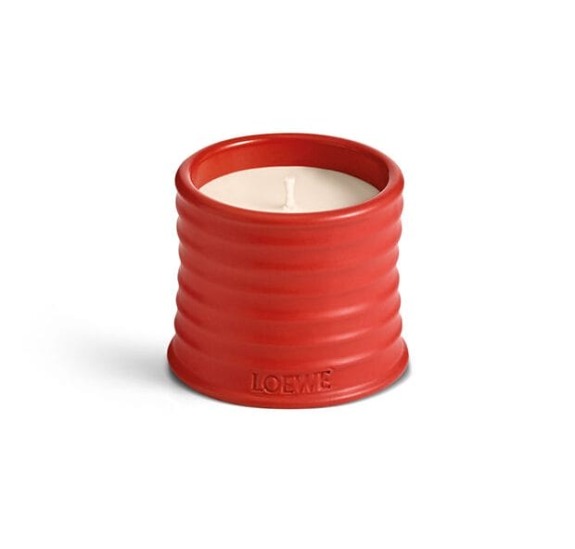 Red LOEWE scented candle in a ribbed ceramic holder.