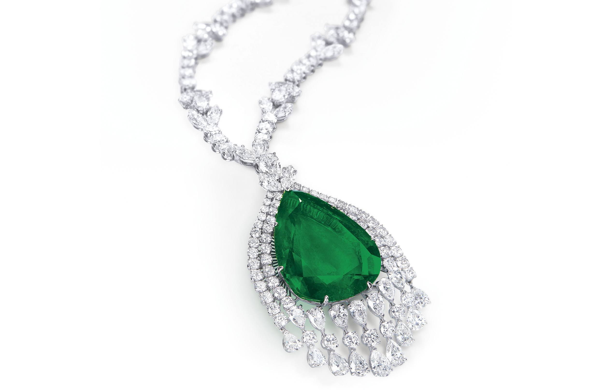 Elegant necklace with a large emerald pendant surrounded by diamonds on a white background.
