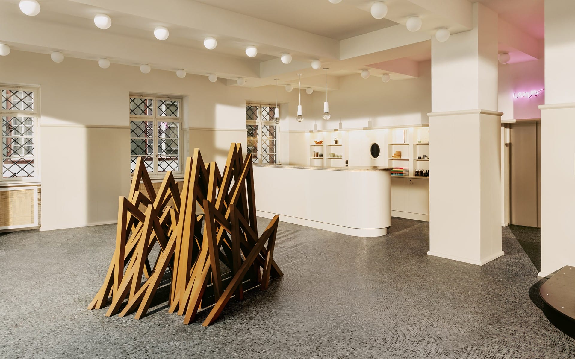 Modern art installation in a spacious, minimalist gallery with neutral tones and geometric design elements.