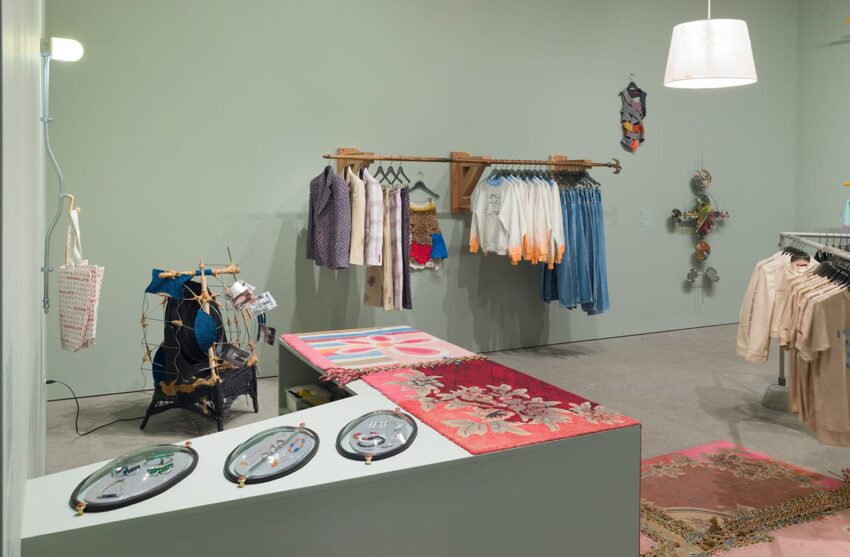 Contemporary clothing store with hanging garments, artistic installations, and unique decor in a modern retail space.