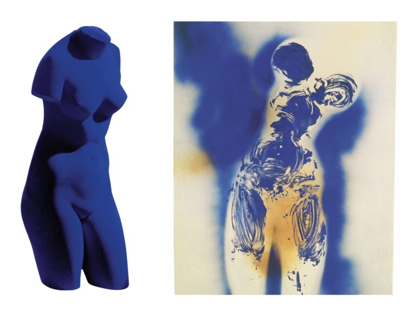 Two abstract blue sculptures representing human figures on a white background.
