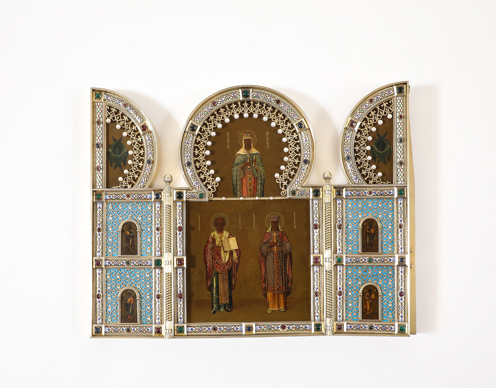 Russian triptych icon with ornate design and three religious figures against a white background.