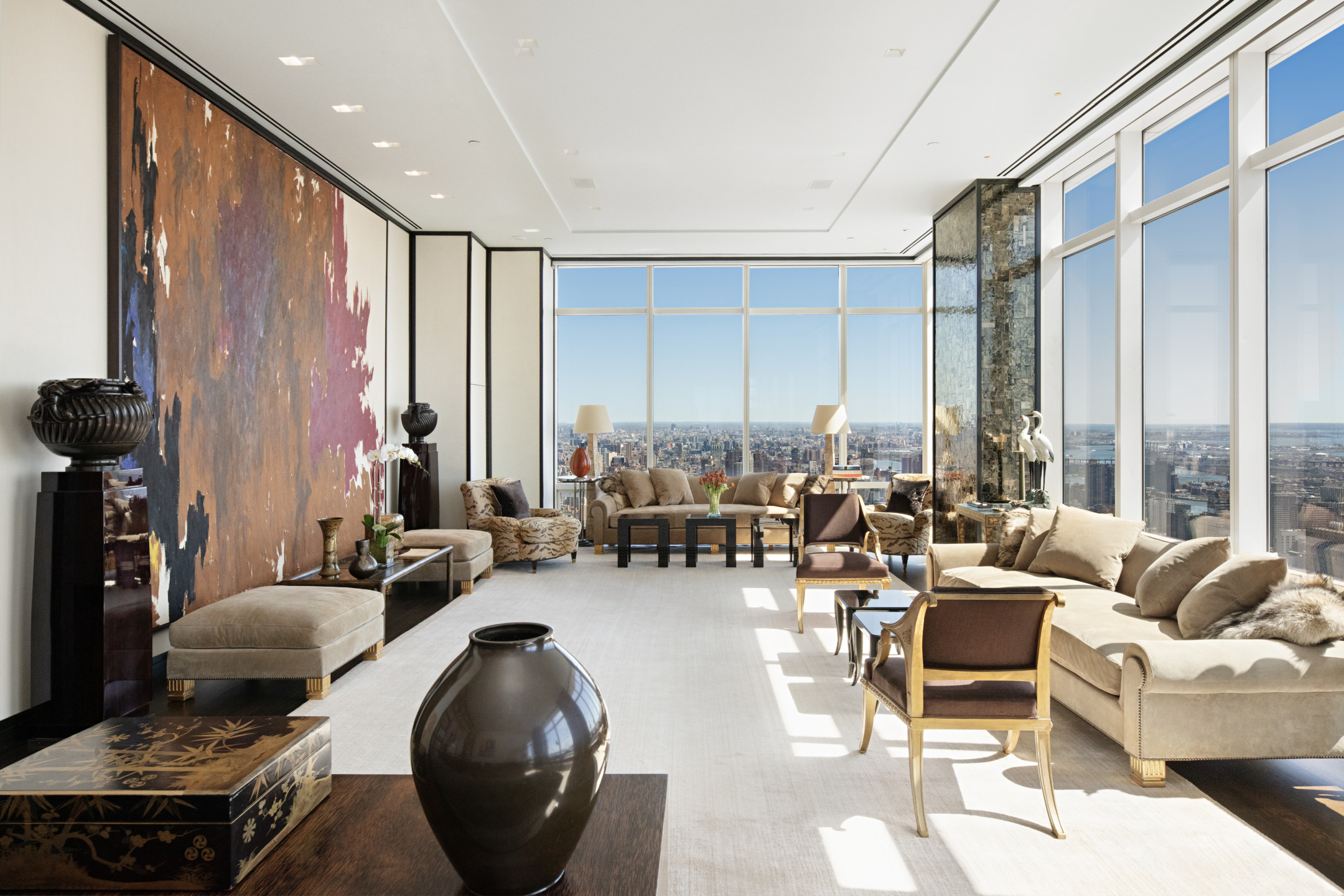 Luxurious modern apartment interior with floor-to-ceiling windows, stylish furniture, and city skyline view in the background.
