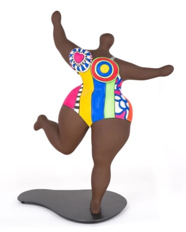 Colorful abstract sculpture of a dancing figure with vibrant patterns on a sleek black base.