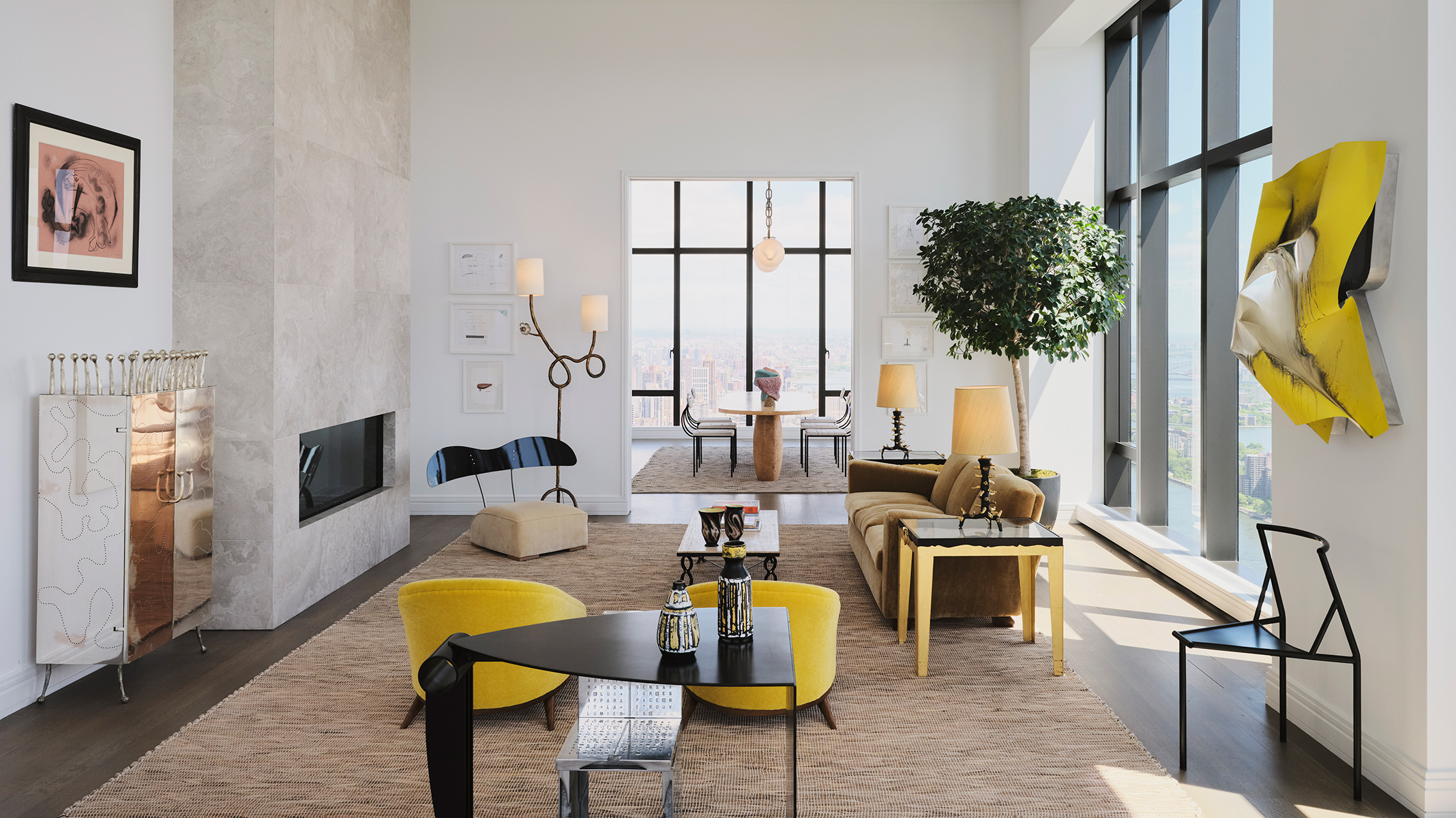 Spacious modern living room with large windows, contemporary furniture, and a neutral color palette featuring yellow accents.