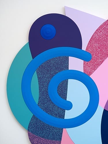 Abstract art with bold, colorful geometric shapes including a large blue spiral on a textured multicolored background.