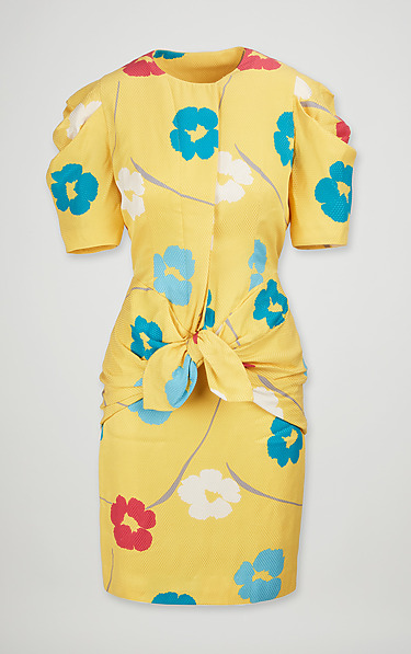 Yellow dress with blue and red floral pattern, short sleeves, and front knot detail.