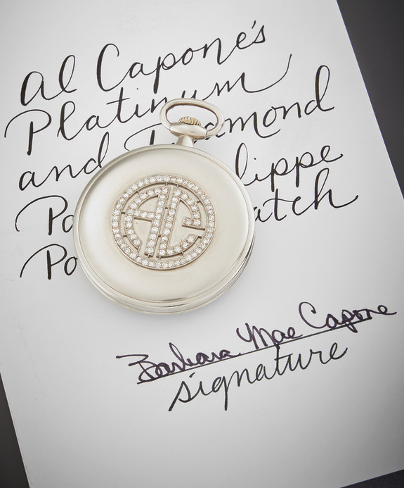 Platinum pocket watch with diamonds on paper showing handwriting and signature.