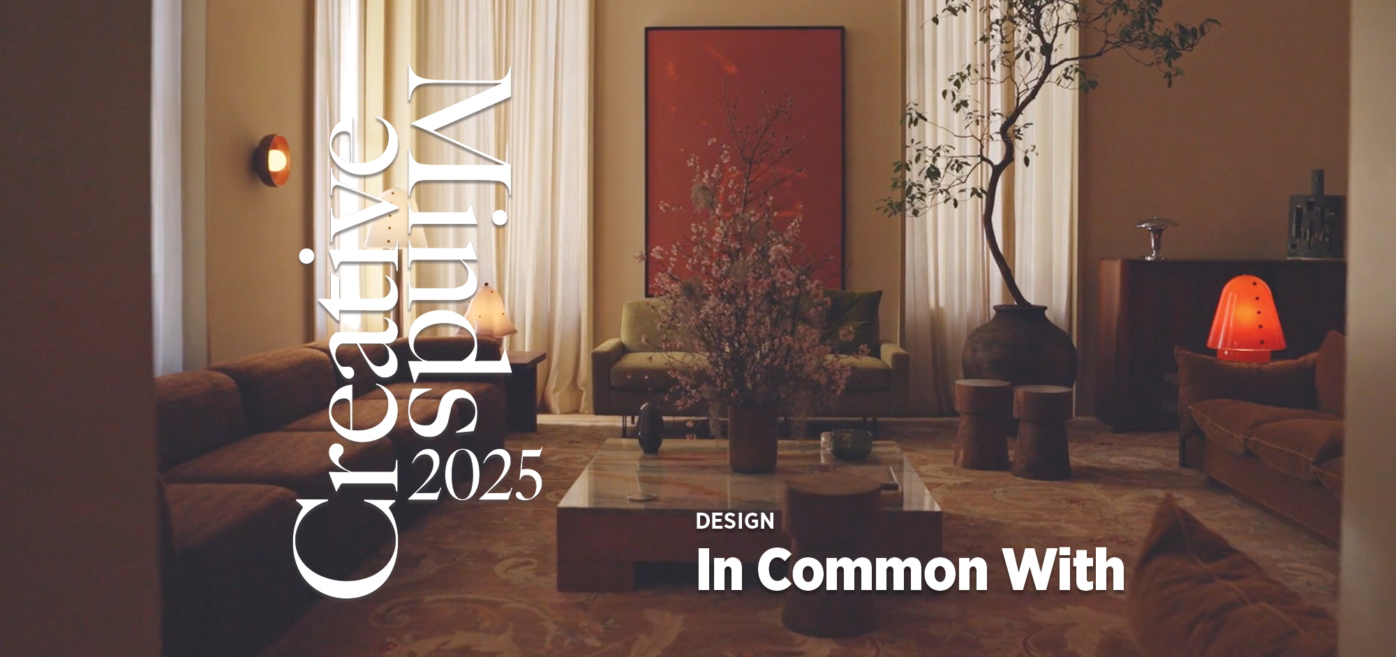Stylish living room with modern decor, large artwork, and elegant furniture, featuring Creative Living 2025 and In Common With text.