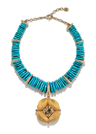 Turquoise beaded necklace with a large gold pendant featuring a central gemstone, displayed on a white background.