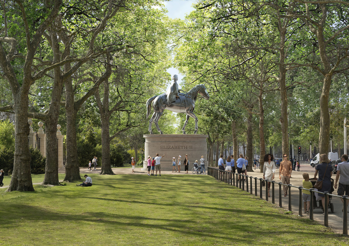 Equestrian statue of a figure on horseback surrounded by trees with people walking nearby in a park setting.