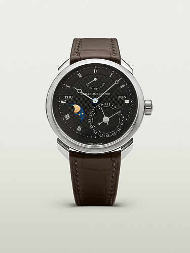 Luxury wristwatch with brown leather strap, black dial, and moon phase indicator on a light background.
