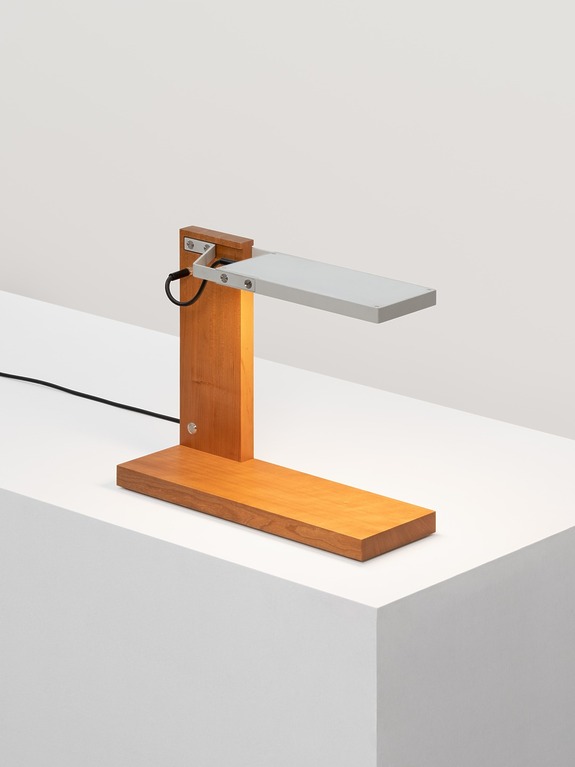 Wooden desk lamp with a modern minimalist design, featuring a rectangular base and shade, placed on a white surface.