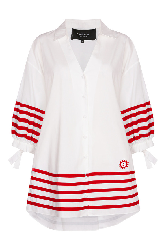 White dress shirt with red horizontal stripes on sleeves and hem, featuring a sun emblem on the lower right side.