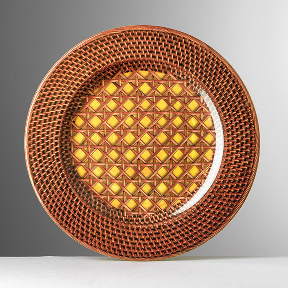 Decorative woven-pattern plate with a geometric design in red and yellow tones against a gray background.