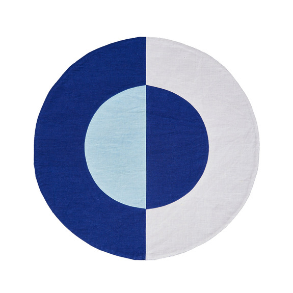 Round fabric with geometric blue and white design featuring semi-circles and contrasting colors.