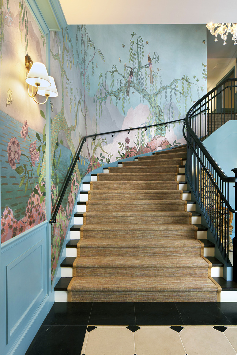 Artistic staircase with floral wallpaper and elegant railing in a stylish, modern interior space.