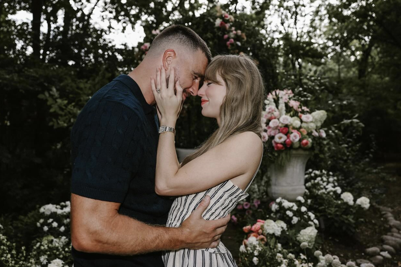 couple embracing in a garden surrounded by vibrant flowers