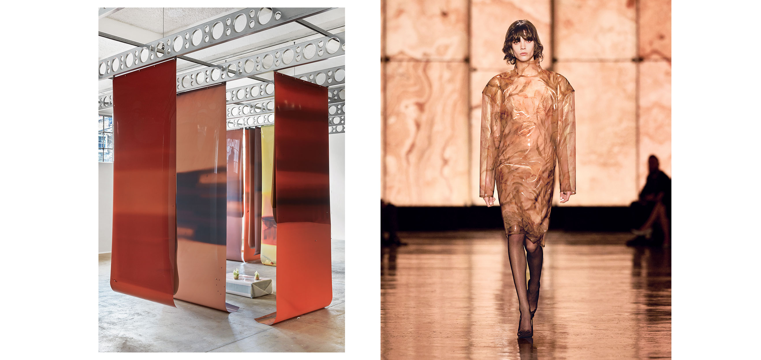 Modern art installation with red panels and a model on a runway wearing a sheer outfit with a marbled design.