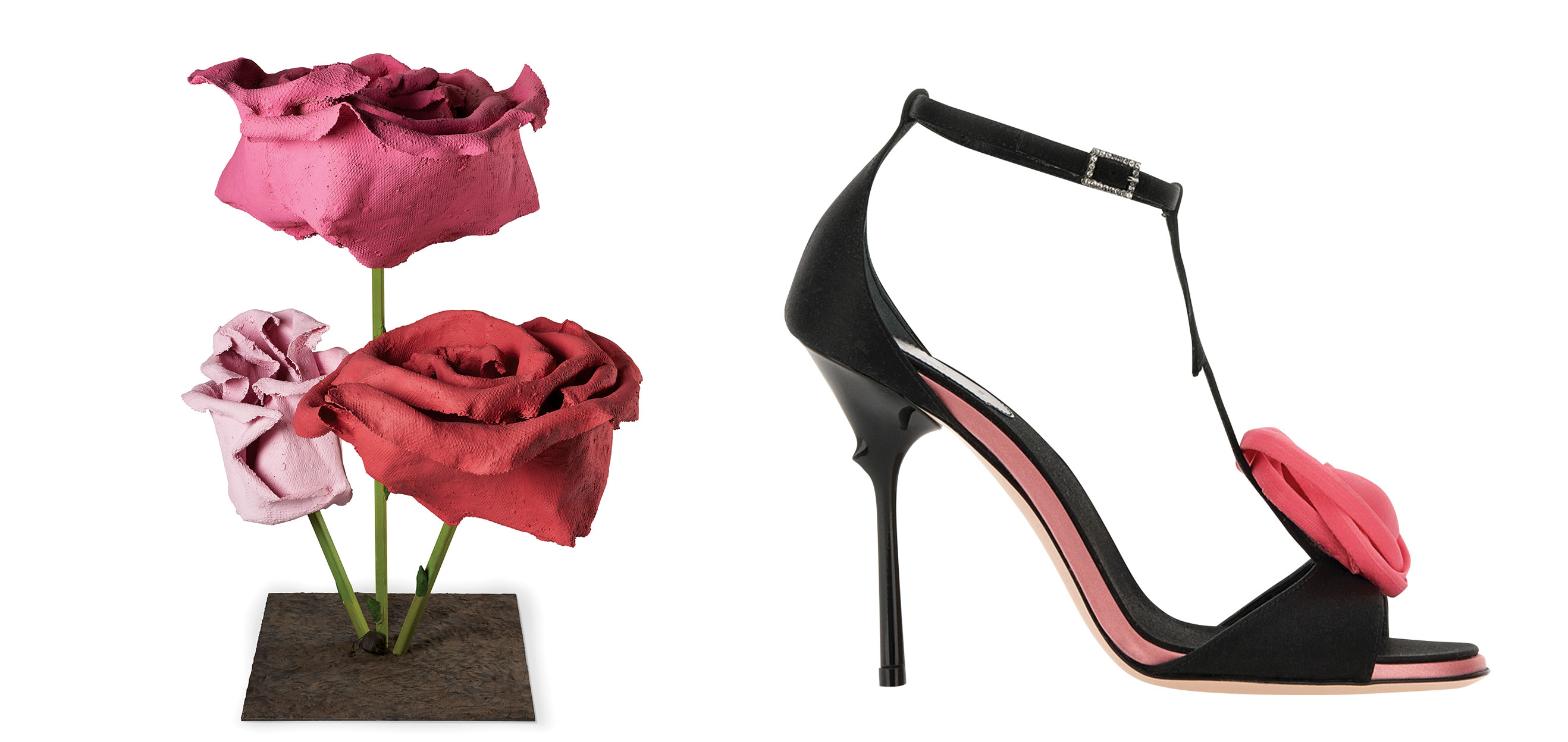 Pink and red sculpted roses on a stand beside a black high-heeled shoe with a pink rose detail.