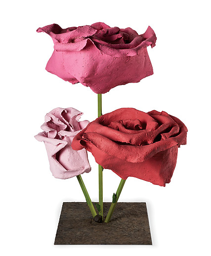 Sculpture of three colorful roses crafted from clay on a metal base, showcasing detailed textures and vibrant hues.