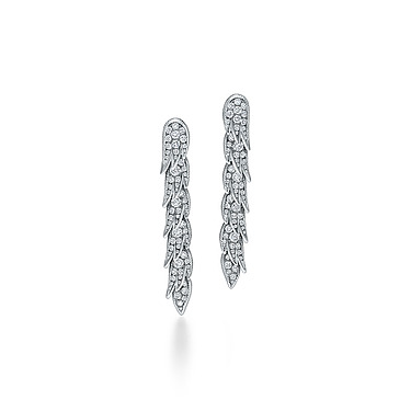 Silver feather-shaped earrings adorned with sparkling diamonds placed on a white background.