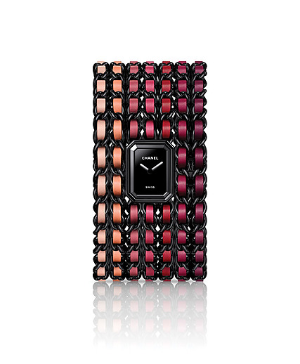 Chanel wristwatch with a black face and multicolored chain link band in shades of orange and burgundy.