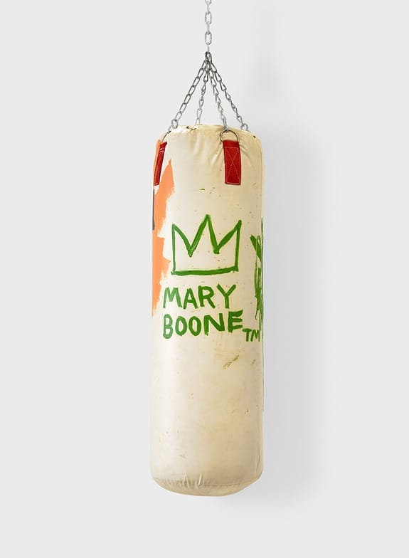 Hanging punching bag with graffiti-style artwork, including a crown and text saying "Mary Boone," on a white background.
