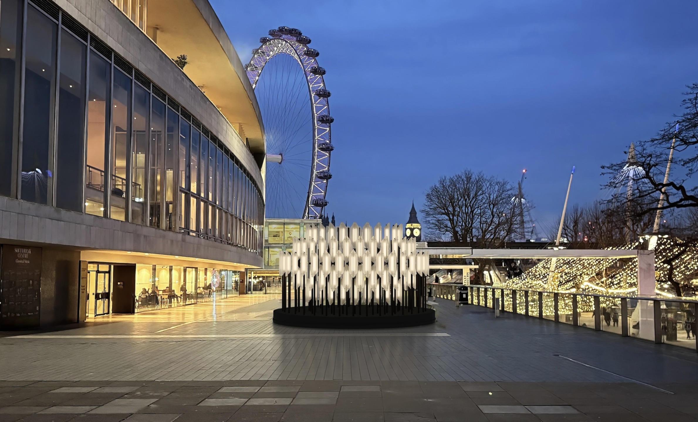 Illuminated modern art installation outside a building with the London Eye and Big Ben in the background at dusk.