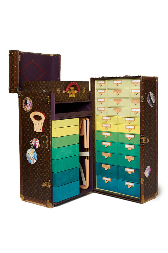 Luxurious trunk with colorful stacked drawers and an open lid, showcasing vibrant storage compartments and elegant design.