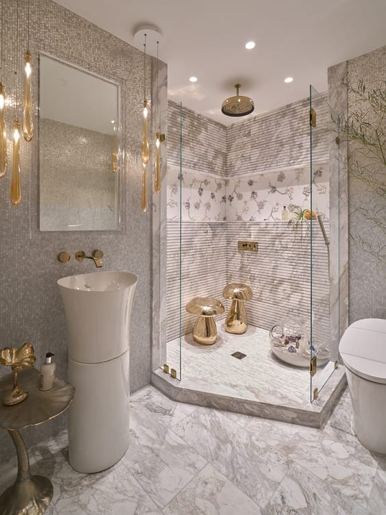 Luxurious bathroom with marble floors, glass shower, modern fixtures, elegant lighting, and decorative wall patterns.