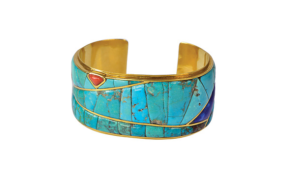 Gold cuff bracelet with turquoise and multicolored stone inlays, featuring abstract geometric patterns.