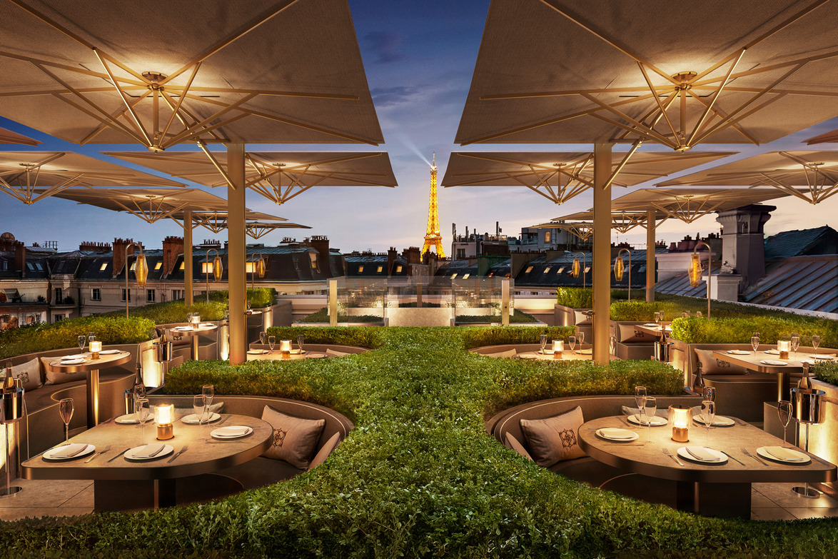 Rooftop restaurant with elegant round tables and view of the Eiffel Tower in the background at dusk.