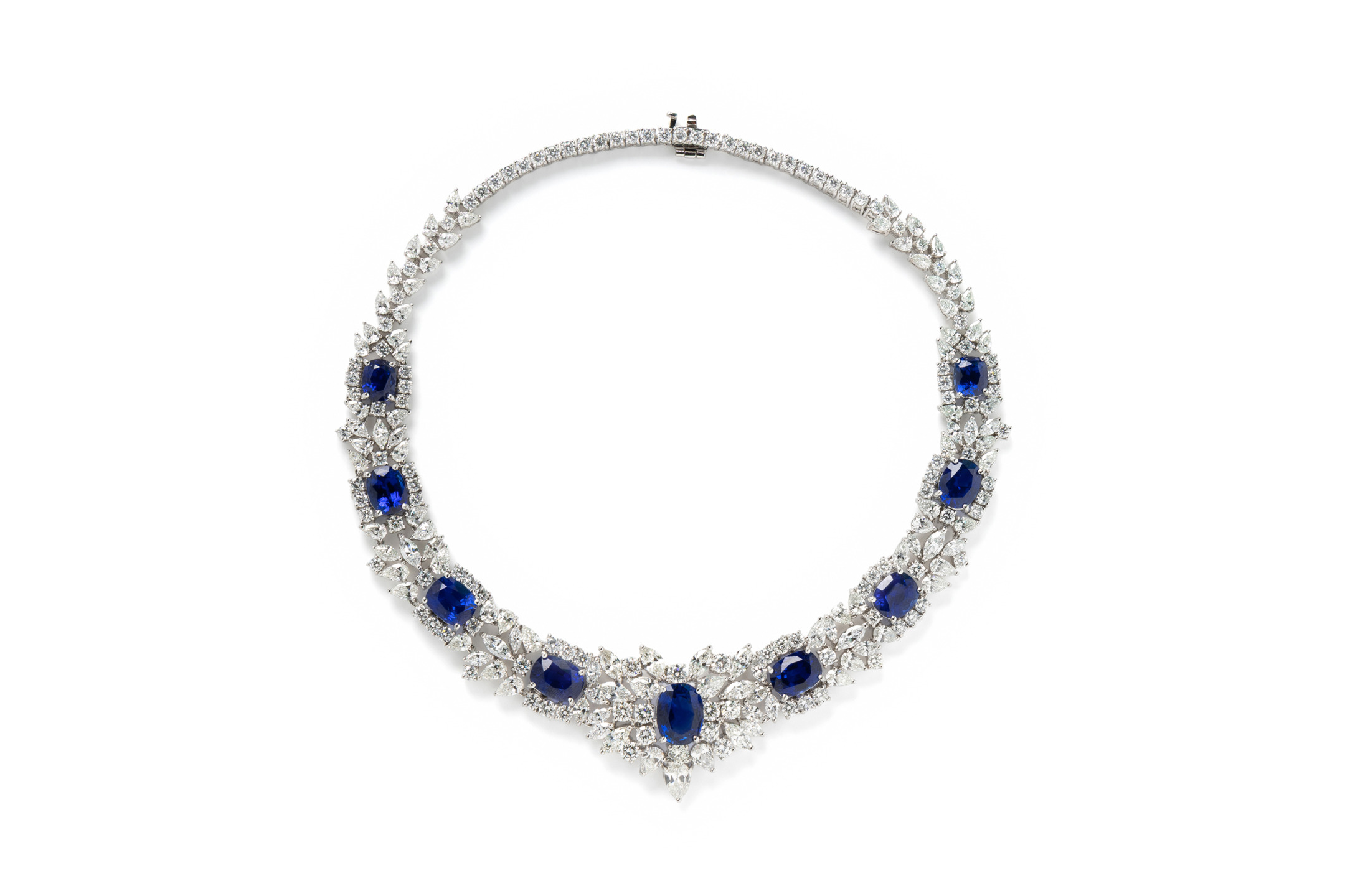 Elegant silver necklace with multiple blue gemstones and intricate detailing.