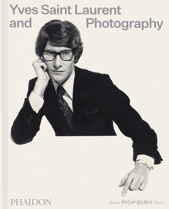 Book cover featuring a person in a suit and glasses, titled "Yves Saint Laurent and Photography" from Phaidon.
