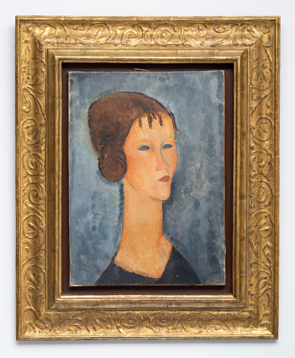 Painting of a woman with elongated features and dark hair against a blue background, set in an ornate gold frame.
