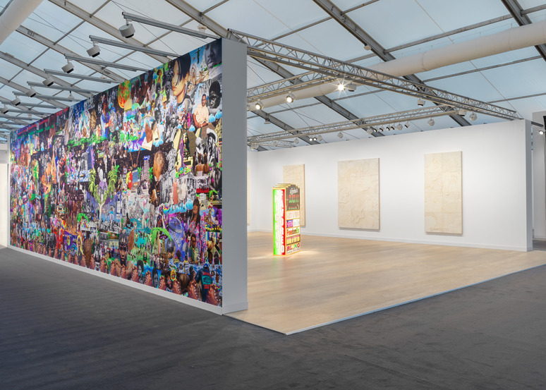 Contemporary art exhibition with colorful mural on one wall and three monochrome canvases on the opposite wall in a bright gallery space