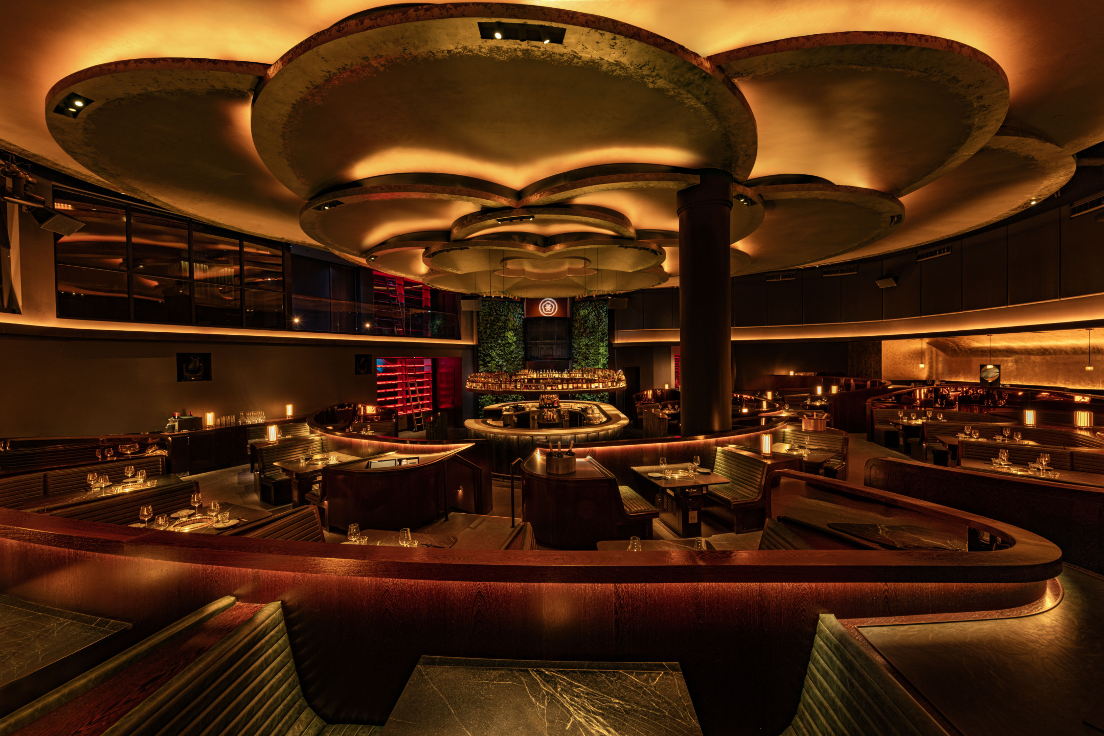 Luxurious restaurant interior with warm lighting, round seating, and elegant decor creating an inviting and stylish ambiance.