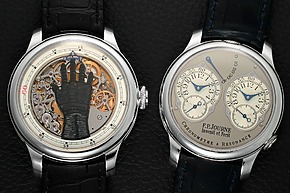 Two luxury wristwatches on black leather surface, showcasing detailed mechanisms and elegant leather straps.